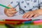 Close-up of childs hands drawing. Boy, drawing a picture for fathers day. Small boy draws at the table