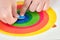 Close up. Childâ€™s hand, kidâ€™s hand is putting last piece jigsaw of color puzzle on the target. Target achievement