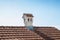 Close up chimney like a little house on the roof