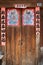 Close up of chinese doors with posters of gods to protect from the demons