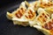 Close up of Chinese fried dumplings on a frying pan.