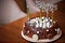 A close-up of chocolate birthday cake. Holiday treat. Healthy cake for a child, decorated with candles and fireworks with the word