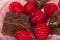 Close up of chocolate brownies and raspberries