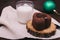 Close-up of chocolate cake, glass of milk and Christmas ball on
