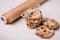 Close up of chocolate chip cookies and parchment paper on wooden
