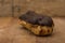 Close up of chocolate eclair on wooden board