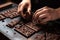 close-up of chocolatier& x27;s hands, molding chocolate into delicate shapes and patterns