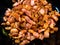 Close-up on chopped, crispy fried bacon on black background