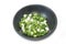 Close up chopped spring onions in black bowl