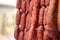 Close up of Chorizo sausages hanging up with string, speciality cuisine food from Spain.