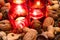 Close-up of Christmas decoration. Nuts and candles. Cozy atmosphere in winter season with candlelight.