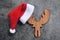 Close up of christmas hat holiday background with red santa hat and decorations on christmas antlers of a deer and Festive Happy