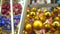 Close up of christmas toys suspended on metal construction in hall in shopping center. Yellow christmas balls hanging on