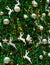 Close up Christmas tree decoration with red, gold, silver, and white balls, silver star and white reindeer. Xmas background.