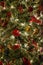 Close up of a christmas tree ornaments baubles ribbons flowers and lights. Christmas card background wallpaper concept