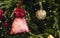 Close up of Christmas tree with ornaments of baubles, snowflakes, teddy bears, gingerbread house, pine cones and lights.