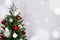 Close up of christmas tree over white brick wall with snow