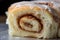 close-up of cinnamon roll, with layers of soft and fluffy pastry and sweet cinnamon filling visible