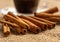 Close up cinnamon sticks and coffee on hessian canvas with wooden background