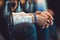 Close-up of the clasped male hands sitting on a leather chair. the speaker is waiting for his turn at the business