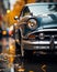 a close up of a classic car parked on a wet street