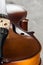 Close up of classical wooden cello on grey textured background.