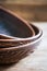 Close up of clay plates with handmade red clay patterns on top of each other on a wooden table