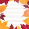 Close-up of clean paper sheet in a lined surrounded by autumn leaves. Top view, space for text