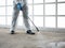 Close up cleaner hand use spray gun sanitizer on industry concrete floor to prevent Covid-19 or Coronavirus pandemic disease while