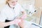 A close-up of the cleaning procedure in the office of cosmetology. The hands of the cosmetologist in pink gloves are