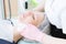 A close-up of the cleaning procedure in the office of cosmetology. The hands of the cosmetologist in pink gloves are