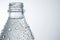 Close-up of a clear water bottle, adorned with refreshing droplets, showcasing purity.