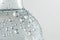 Close-up of a clear water bottle, adorned with refreshing droplets, showcasing purity.