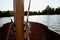 Close up of the cleats on the wooden mast of a small sailing boat dinghy