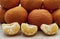 Close-up of clementine mandarins with slices on wooden table.