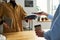 Close-up of clerk with payment terminal and female client with smartphone