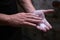 Close up of a climber man using liquid chalk magnesium