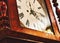 Close up of clock face on an antique grandfather clock with roman numerals