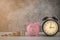 Close-up of clock and pink piggy bank smile with coins stack stair step up growing growth saving money. concept Business Finance,