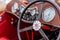 Close up on clocks and dashboard of red MG TF Roadster from 1950s