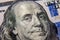 A close-up close-up shot of Benjamin Franklin\\\'s face on a $ 100 bill