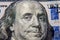 A close-up close-up shot of Benjamin Franklin\\\'s face on a $ 100 bill