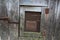 Close up of closed door on old wooden hutch for rabbits on the barnyard