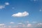 Close up clouds on vast bright blue sky background with breeze