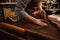 Close up of a cobbler working with leather textile