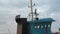 Close-up of the cockpit and exhaust pipe of a kerosene work boat at sea