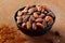 Close up cocoa beans maroon background