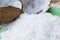 Close up of a coconut and a pile of shredded coconut