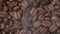 Close-up coffee beans with smoke are roasted and rotated
