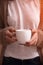 Close-up of coffee cup with knitting needles in in woman hands. Close-up horizontal photo. Freelance creative working and living